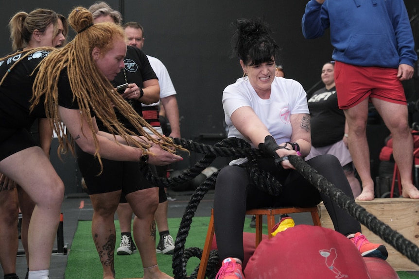 Justine Martin pulls on a rope to compete in the sled pull.