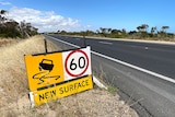 A 60kph roadwork sign on a highway