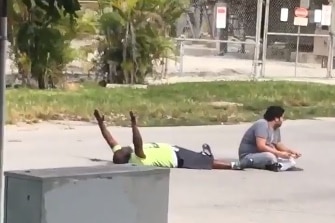 Video still showing Charles Kinsey lying with arms in air