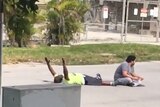 Video still showing Charles Kinsey lying with arms in air