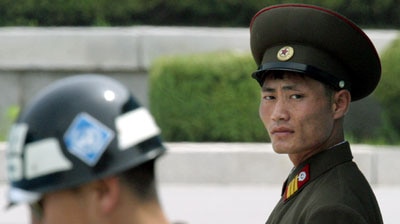 South and North Korean soldiers stand guard in the demilitarised zone