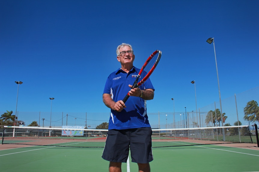 Allan holding a tennis racquet