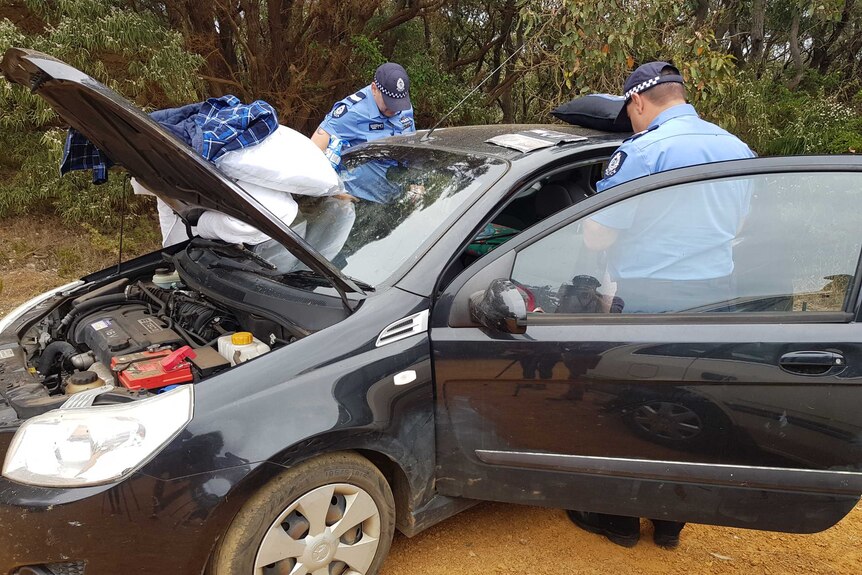 Police officers searching a car belonging to the couple