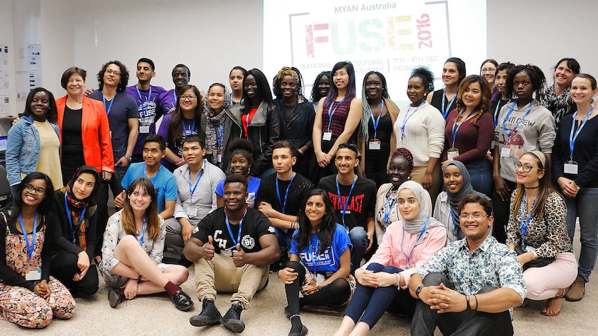 A group photo of around 30 mostly young people from a diverse range of backgrounds.