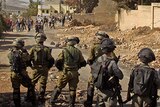 Israeli troops and Palestinian youths in the West Bank