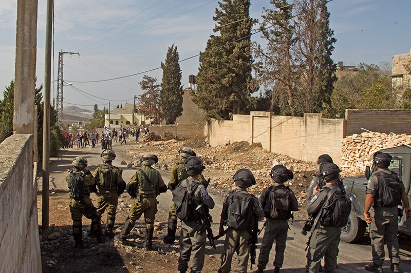 Israeli troops and Palestinian youths in the West Bank