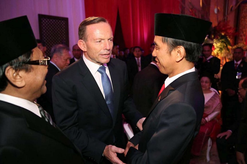 Prime Minister Tony Abbott talks to Indonesian president Joko Widodo