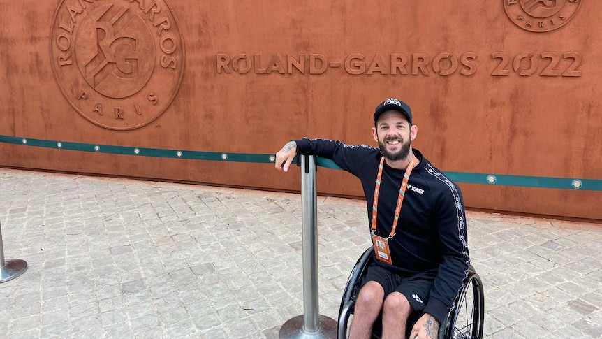 Australian wheelchair tennis player Heath Davidson is pictured next to a sign saying 'Roland-Garros 2022'.