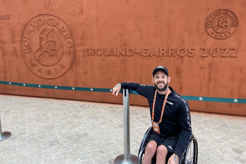 Australian wheelchair tennis player Heath Davidson is pictured next to a sign saying 'Roland-Garros 2022'.