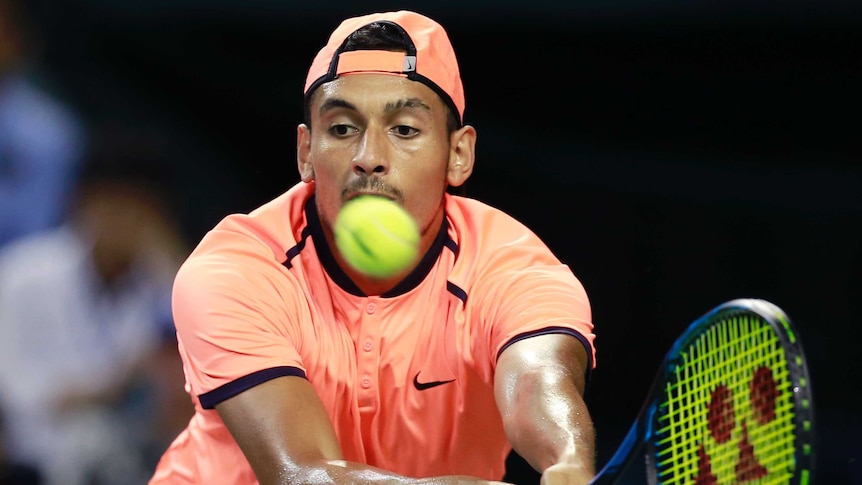 Kyrgios stretches for a backhand at Japan Open