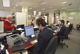 Public servants in Tasmania at desks in Service Tasmania.
