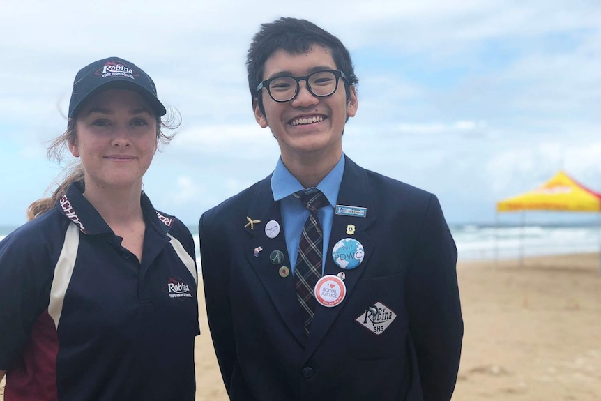 Two year 12 students in Robina High School Uniforms at the beach.