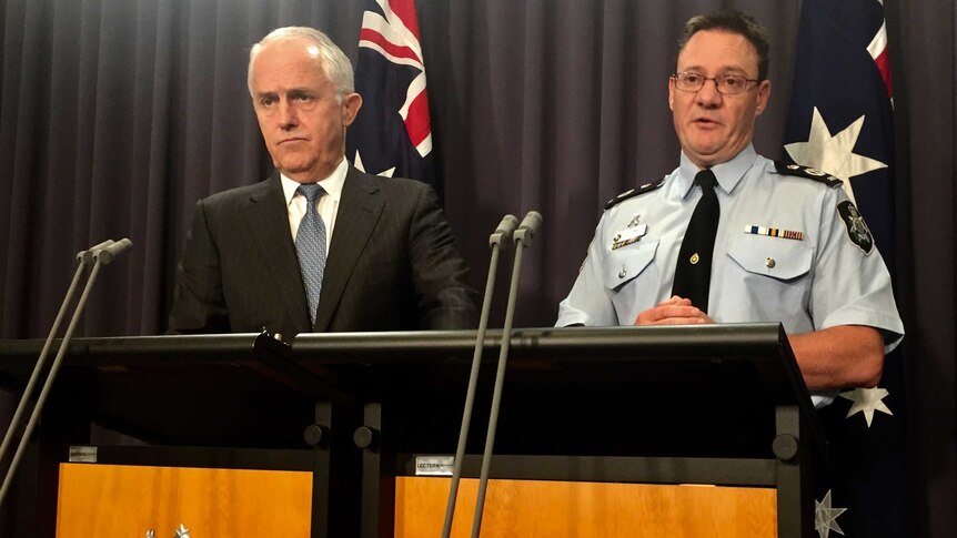 Prime Minister Malcolm Turnbull and AFP Deputy Commissioner Mike Phelan speak at a press conference.