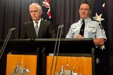 Prime Minister Malcolm Turnbull and AFP Deputy Commissioner Mike Phelan speak at a press conference.