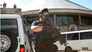 Heavily armed RAMSI police stand guard outside the Solomon Islands Parliament in Honiara.