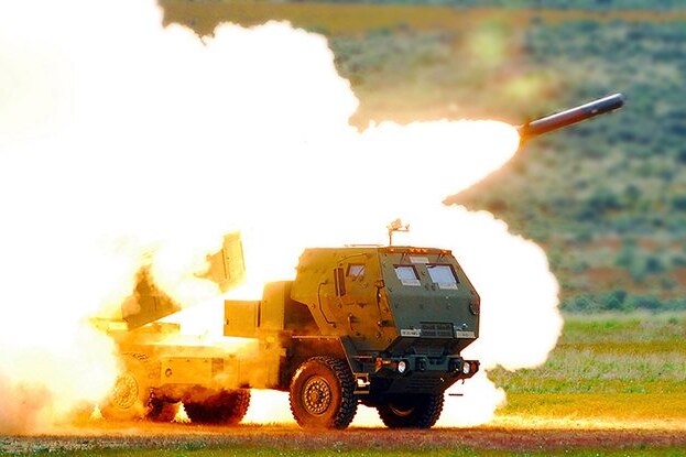 A rocket is fired from a truck with a large explosion of fire.