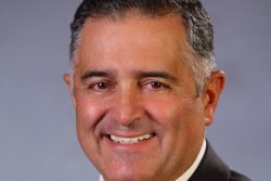 Telmo Languiller smiles at the camera in a portrait shot supplied by the Parliament of Victoria.