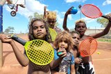 A group of children with tennis rackets