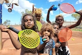 A group of children with tennis rackets