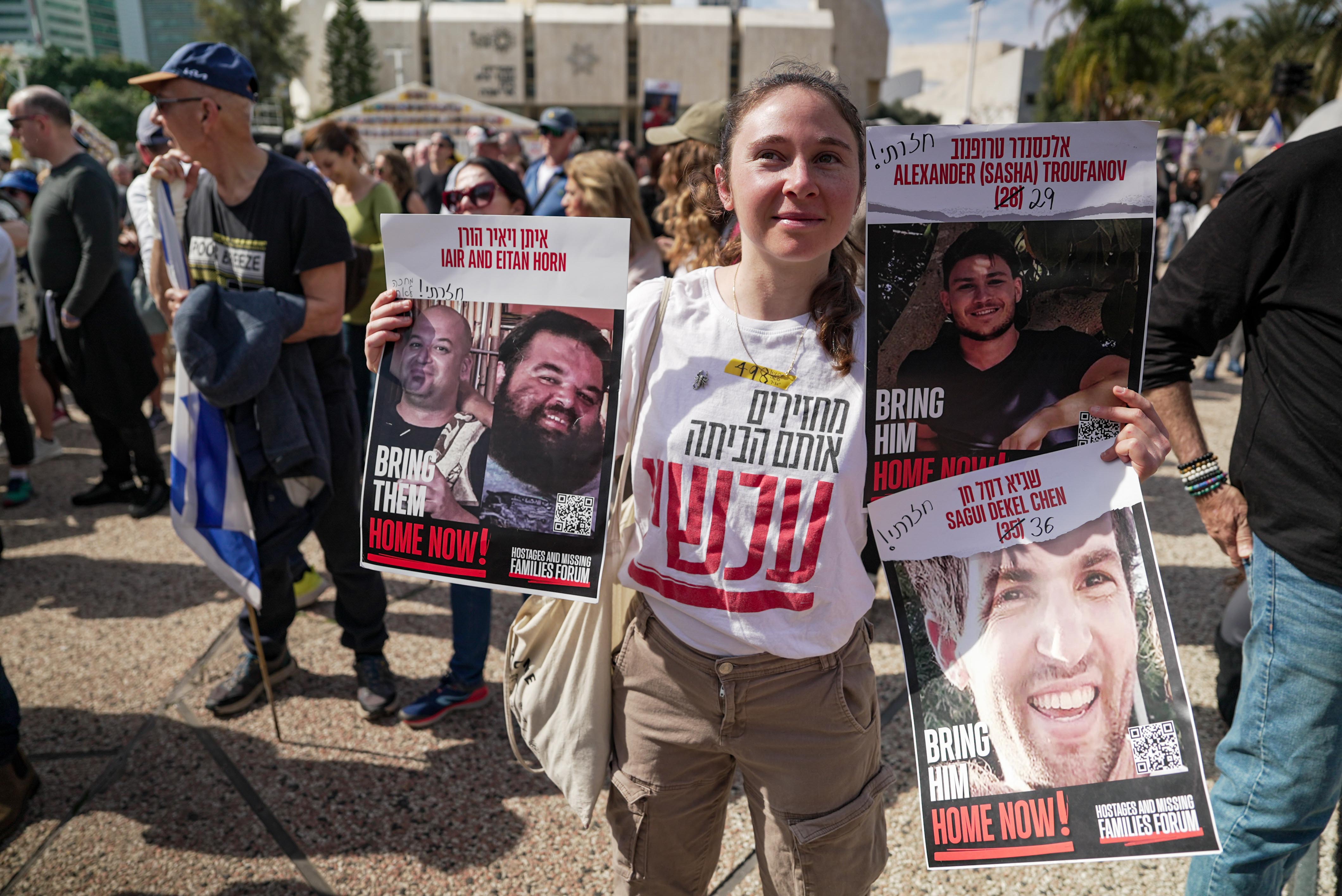 Woman holds up posters