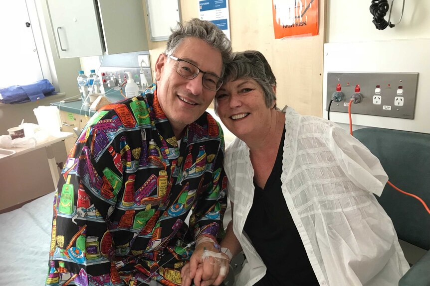 David and Maureen Santamaria sit together in a hospital room