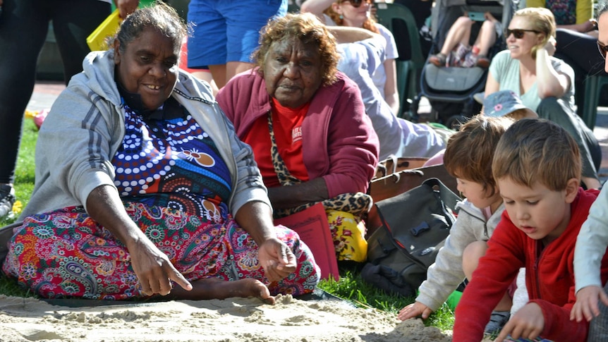 Anmatyerr woman April Campbell (l) and senior Anmatyerr elder Clarrie Nagamara sharing language in Hobart.
