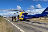 A rescue helicopter parked on a road 