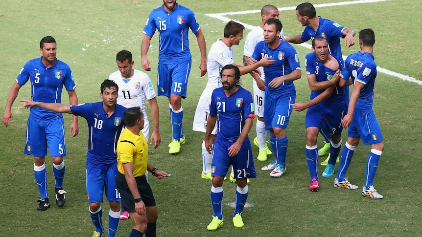 Chiellini signals to his shoulder after apparent Suarez bite