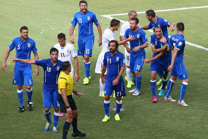 Chiellini signals to his shoulder after apparent Suarez bite