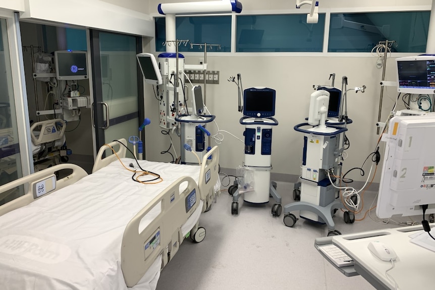 An ICU unit in a hospital is set up with a bed and monitors.