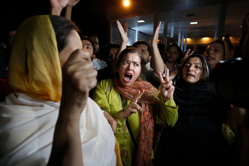 Supporters of Pakistan's Prime Minister Imran Khan chant slogans outside the National Assembly.