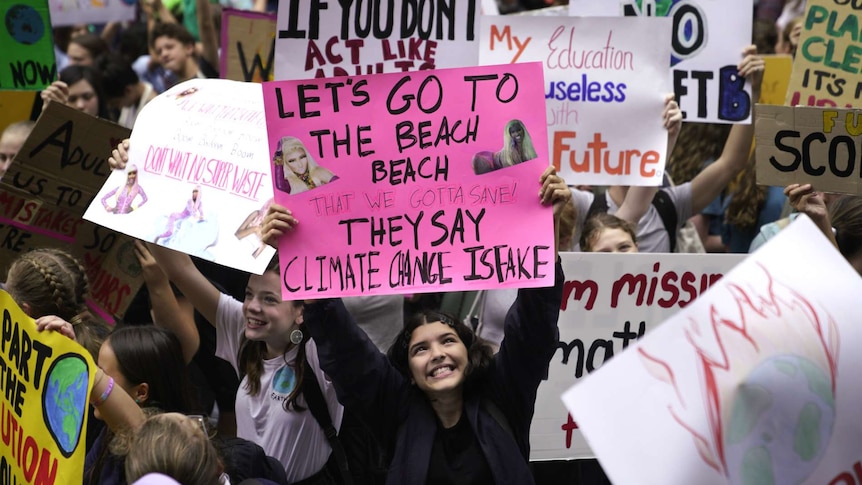 young girl with pink protest sign