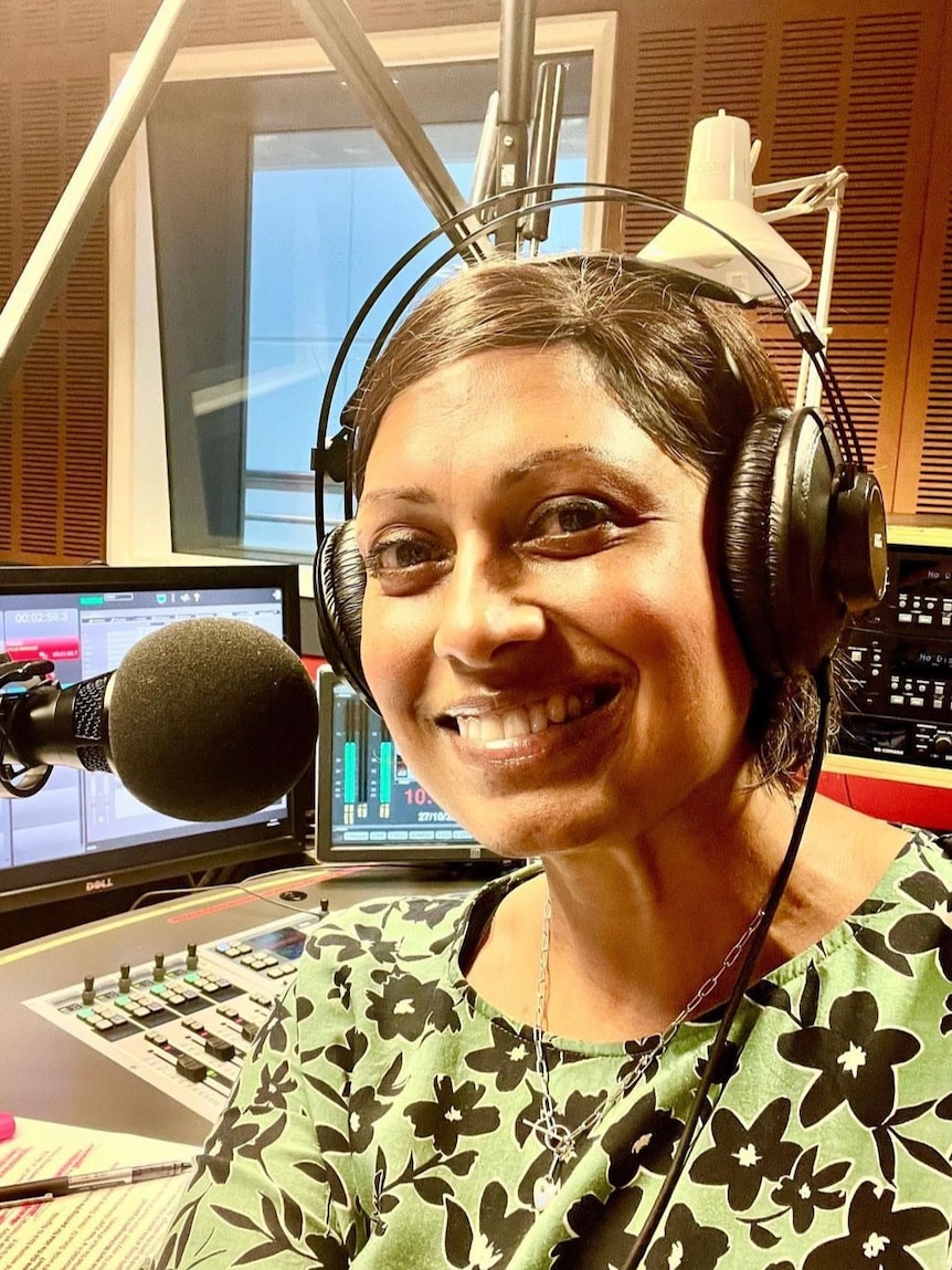 Woman in radio studio with headphones on.