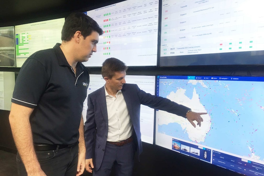 Lifeflight Chief Operations Officer Brian Guthrie points at a map on a screen with a colleague.