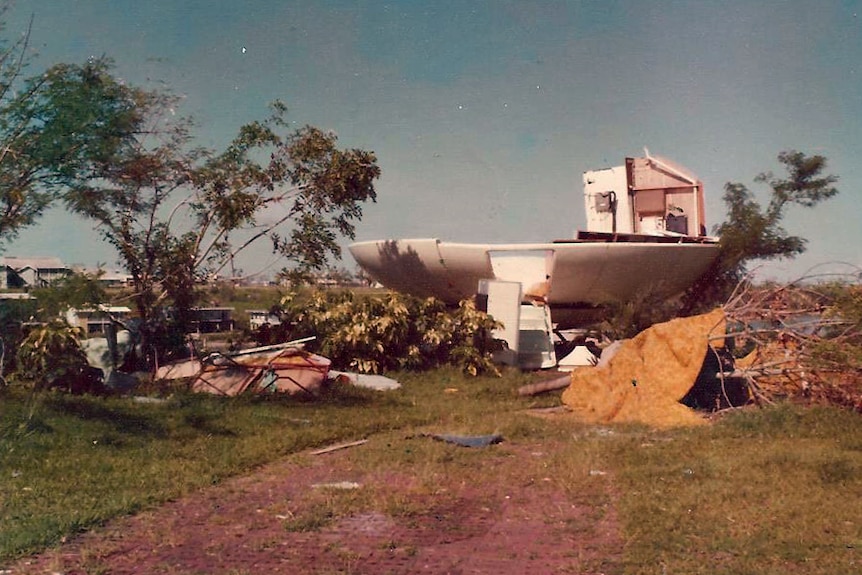 A smashed UFO shaped house on a hill.