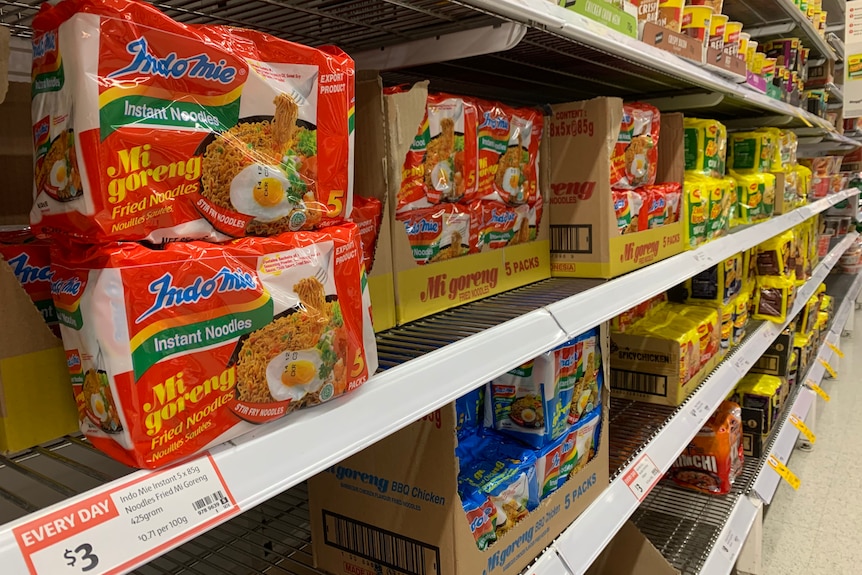 Indomie Instant noodles in two different flavors sitting on the supermarket shelf