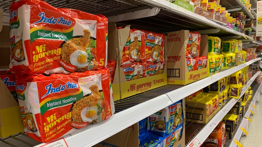Indomie Instant noodles in two different flavors sitting on the supermarket shelf