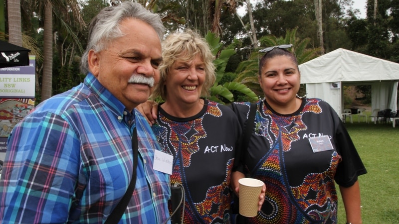 A man and two women stand together