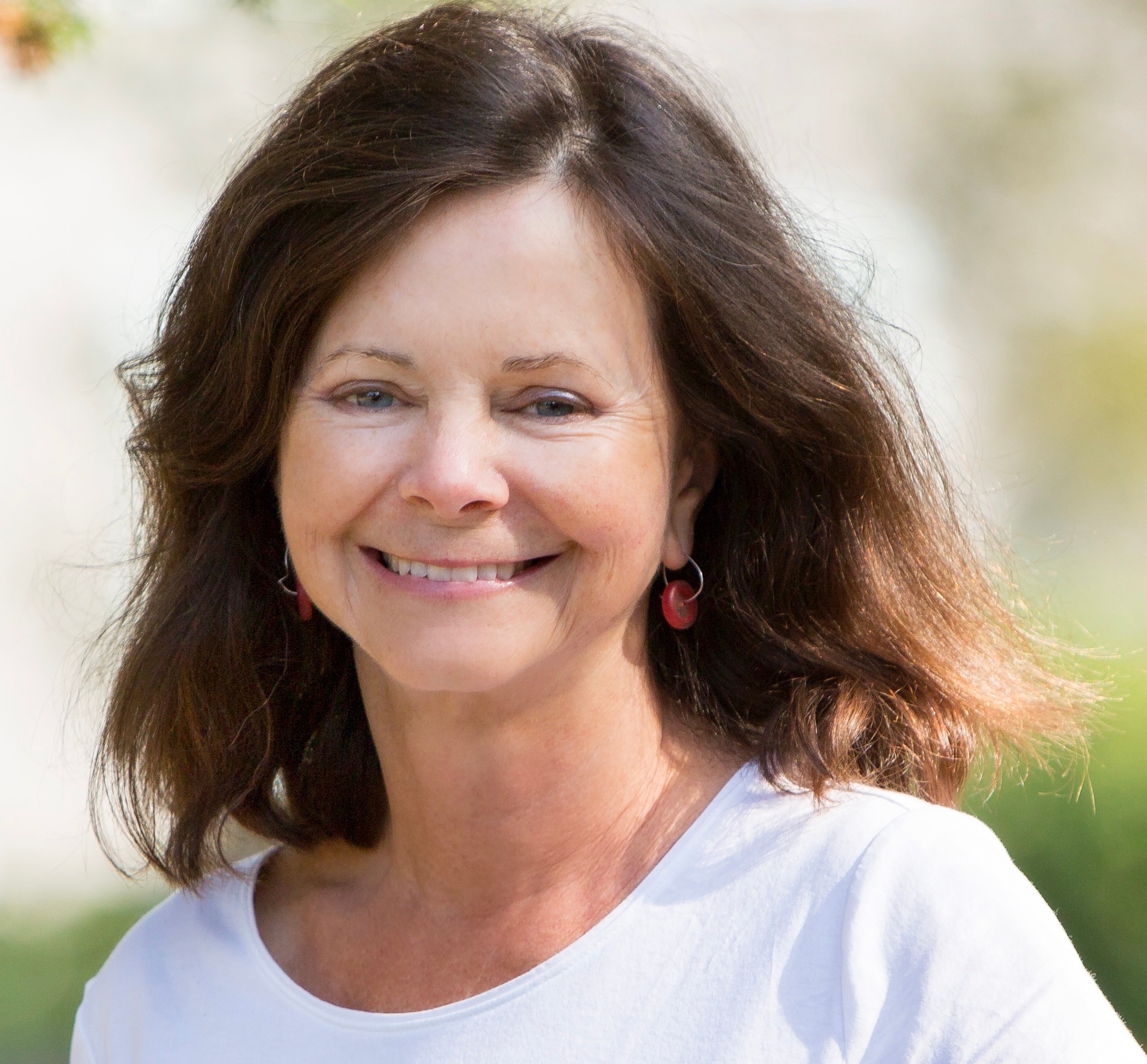 Woman with dark hair smiles at camera 