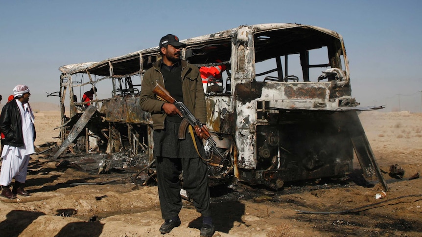 Pakistan soldier guards site of bus attack