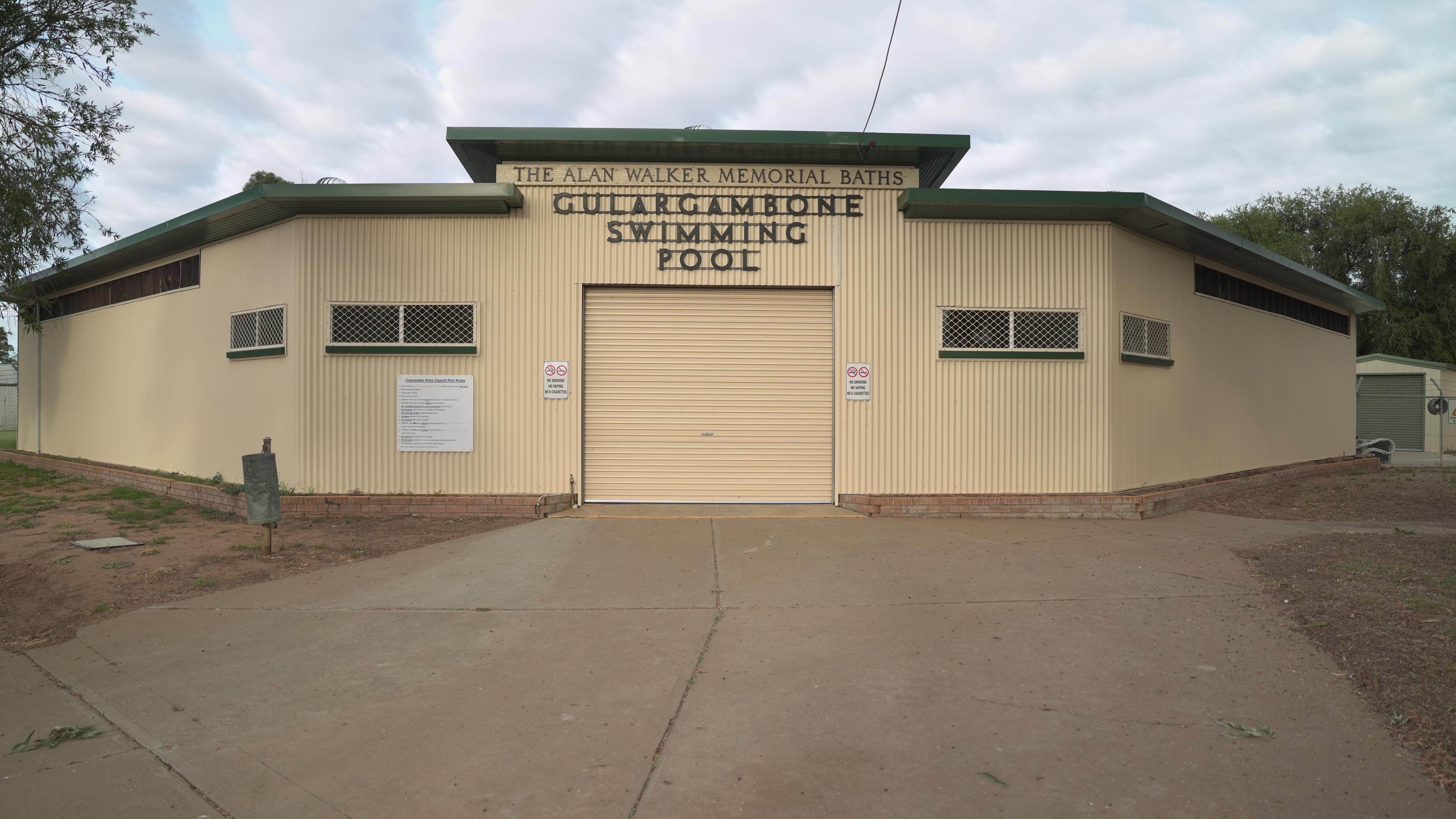 A yellow exterior of a building with the words Gulargambone Pool on the front.