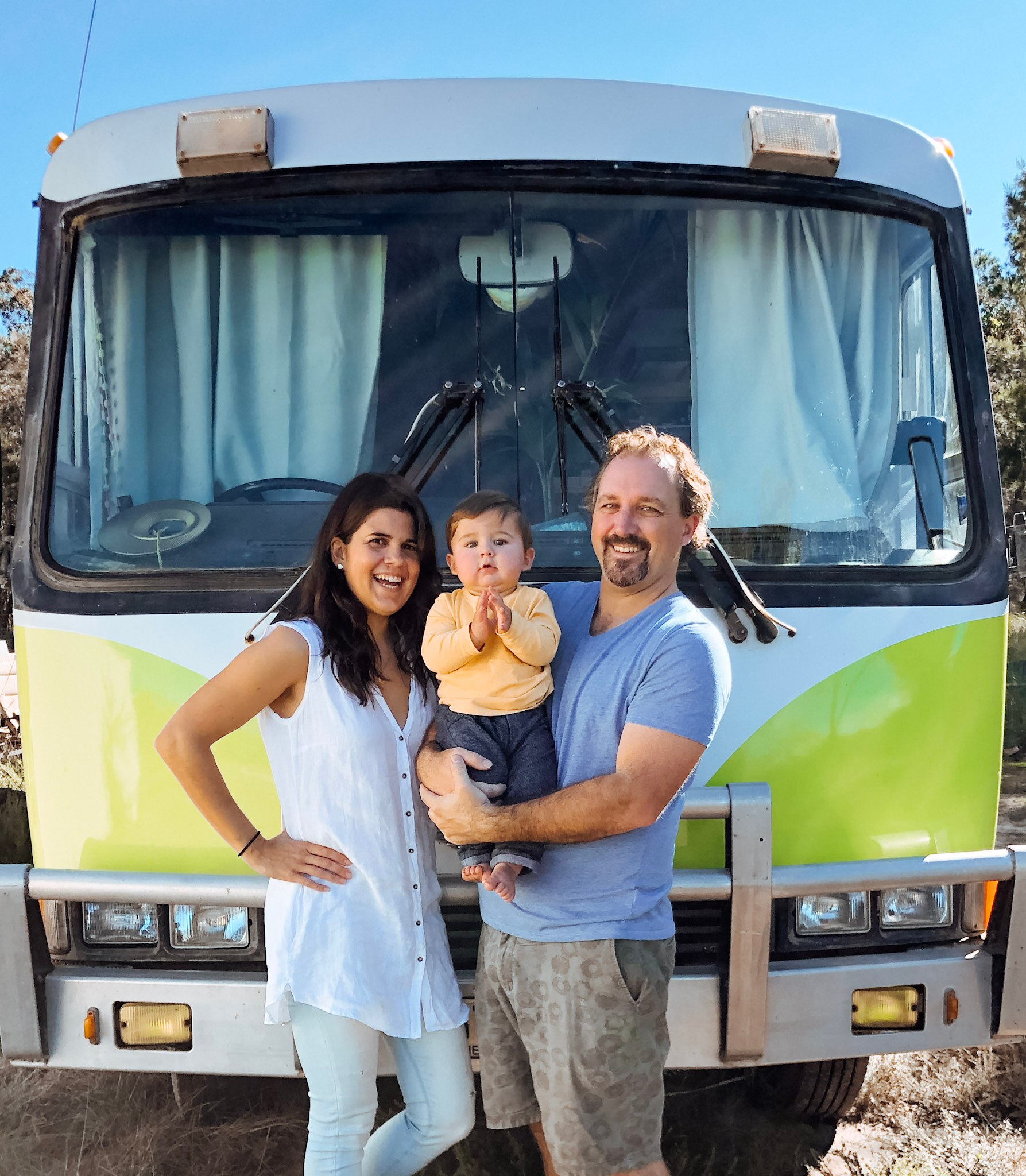 Kevin Craft, his wife Cristina and son Marco stand in front of a bus that serves as their home.