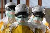 Health care workers in protective suits
