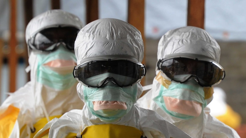 Health care workers in protective suits