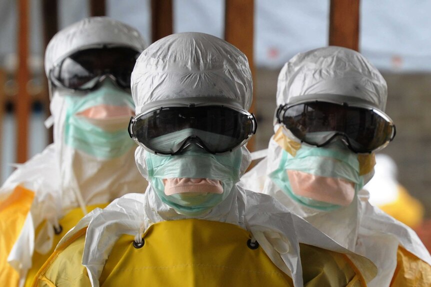 Health care workers in protective suits