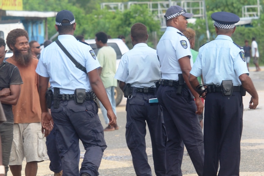 Police officers monitoring the town in Auki, Solomon Islands.