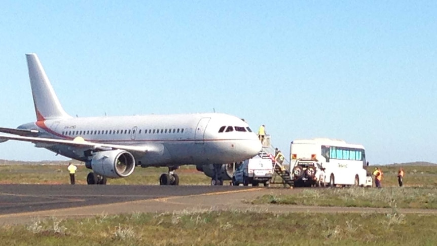 Asylum seekers loaded onto plane in Karratha headed to Christmas Island