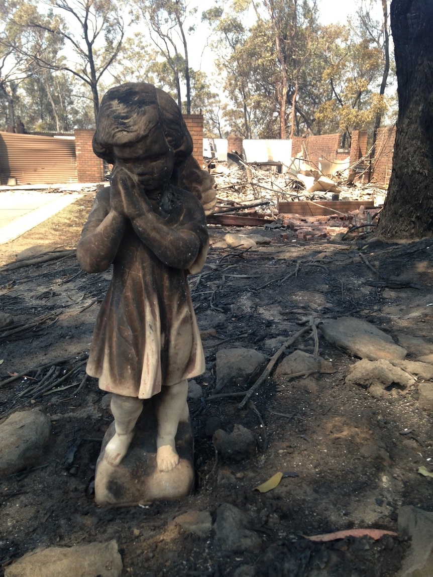 Angel statue in front of house destroyed by fire