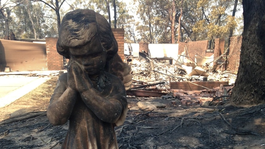 Angel statue in front of house destroyed by fire