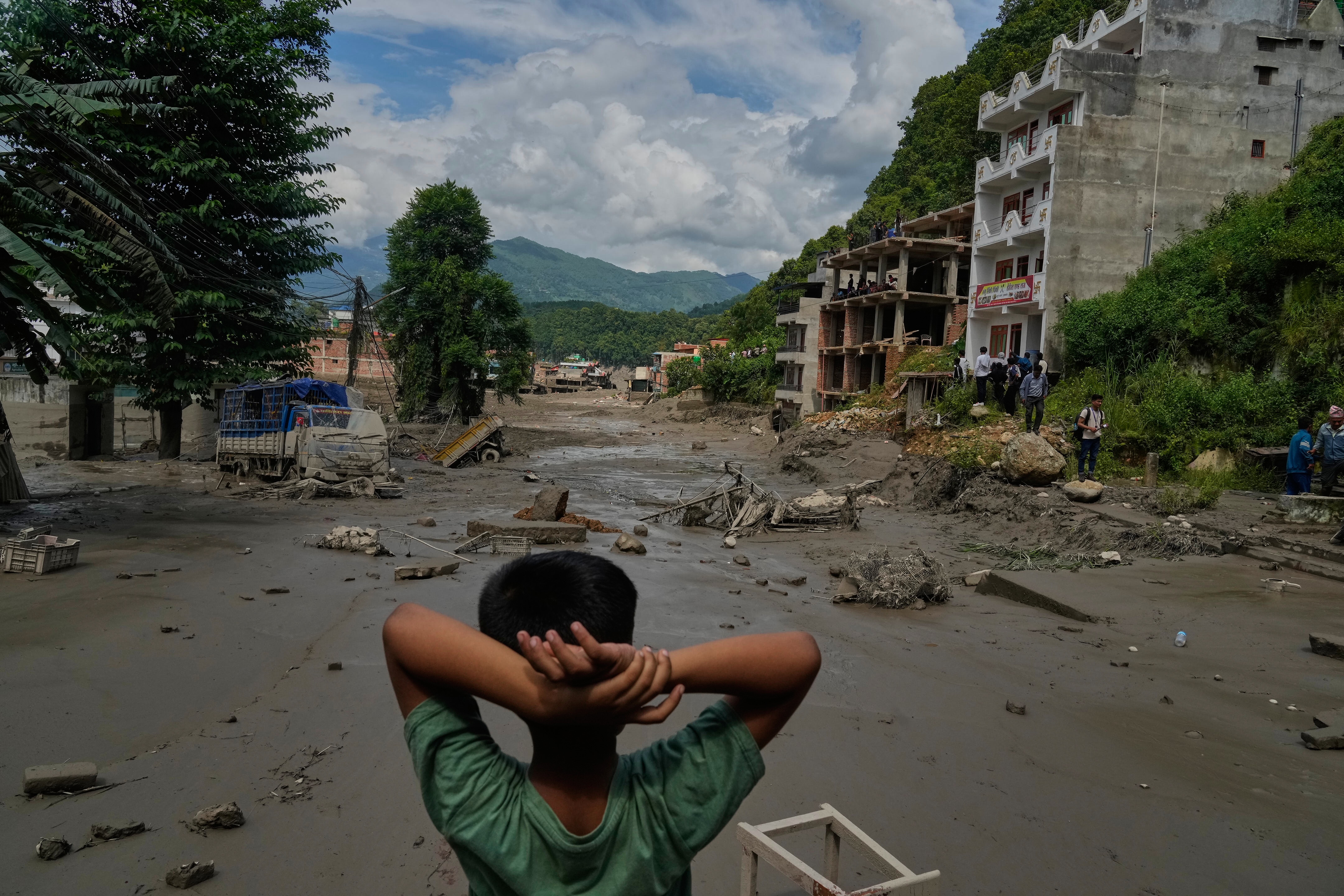 Survivors say family members were swept away by Nepal-Tibet floods